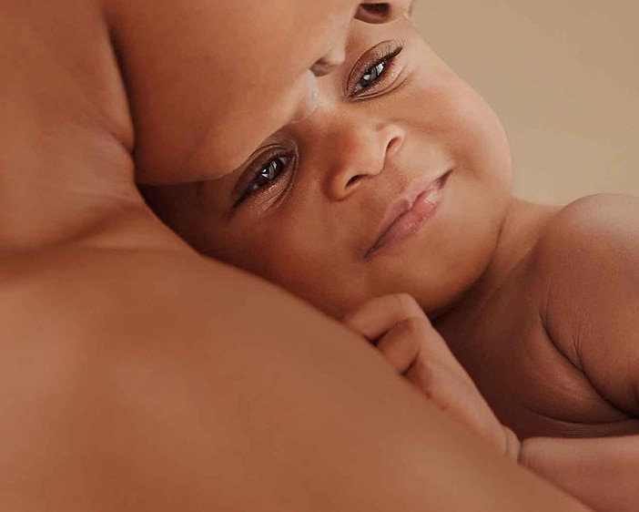 Baby lying on the chest of the mother 