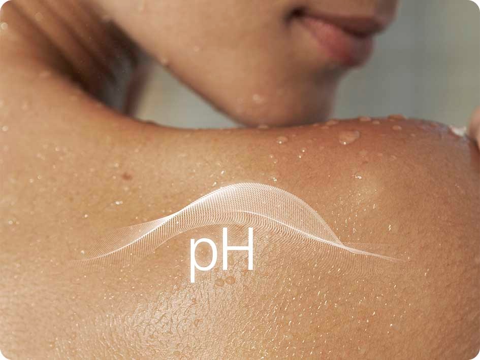 Wet naked woman touching her shoulder with her chin, with a pH level icon indication