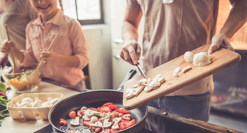 A happy family cooking dinner together  
