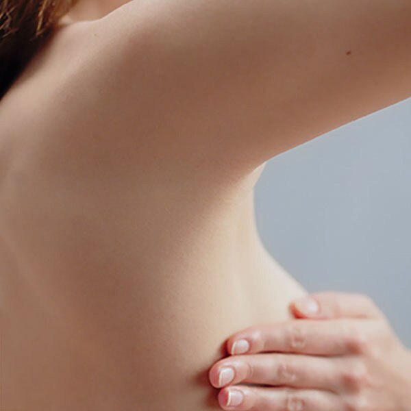 Woman touching her breast and armpits Woman touching her breast and armpits
